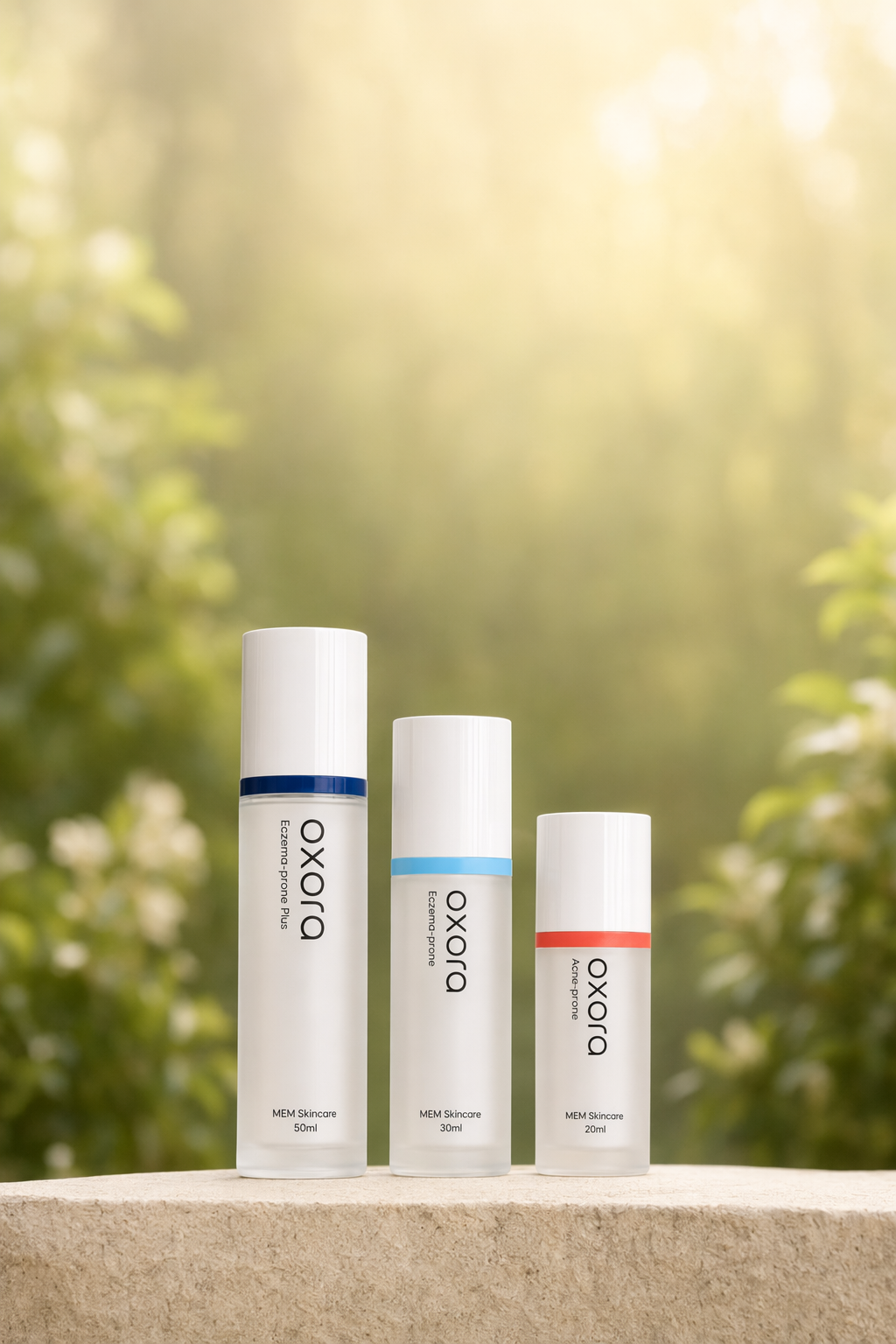 Oxora Acne-prone, EP, and EP Plus on a stone ledge — warm garden bokeh behind
