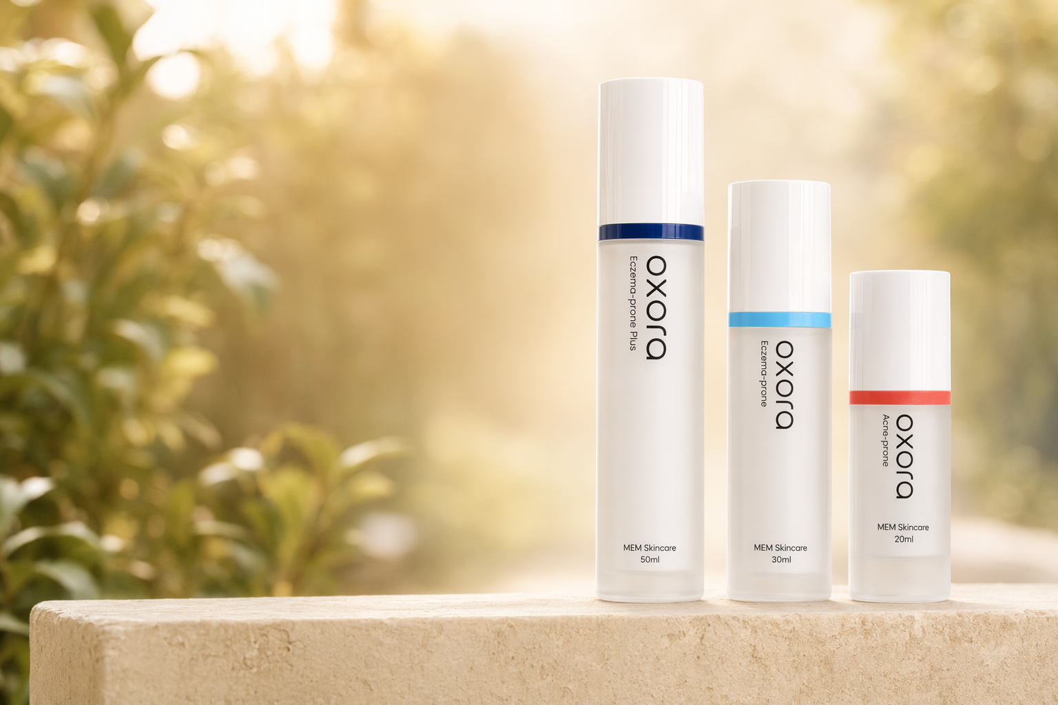 Oxora Acne-prone, EP, and EP Plus on a stone ledge — warm garden bokeh behind