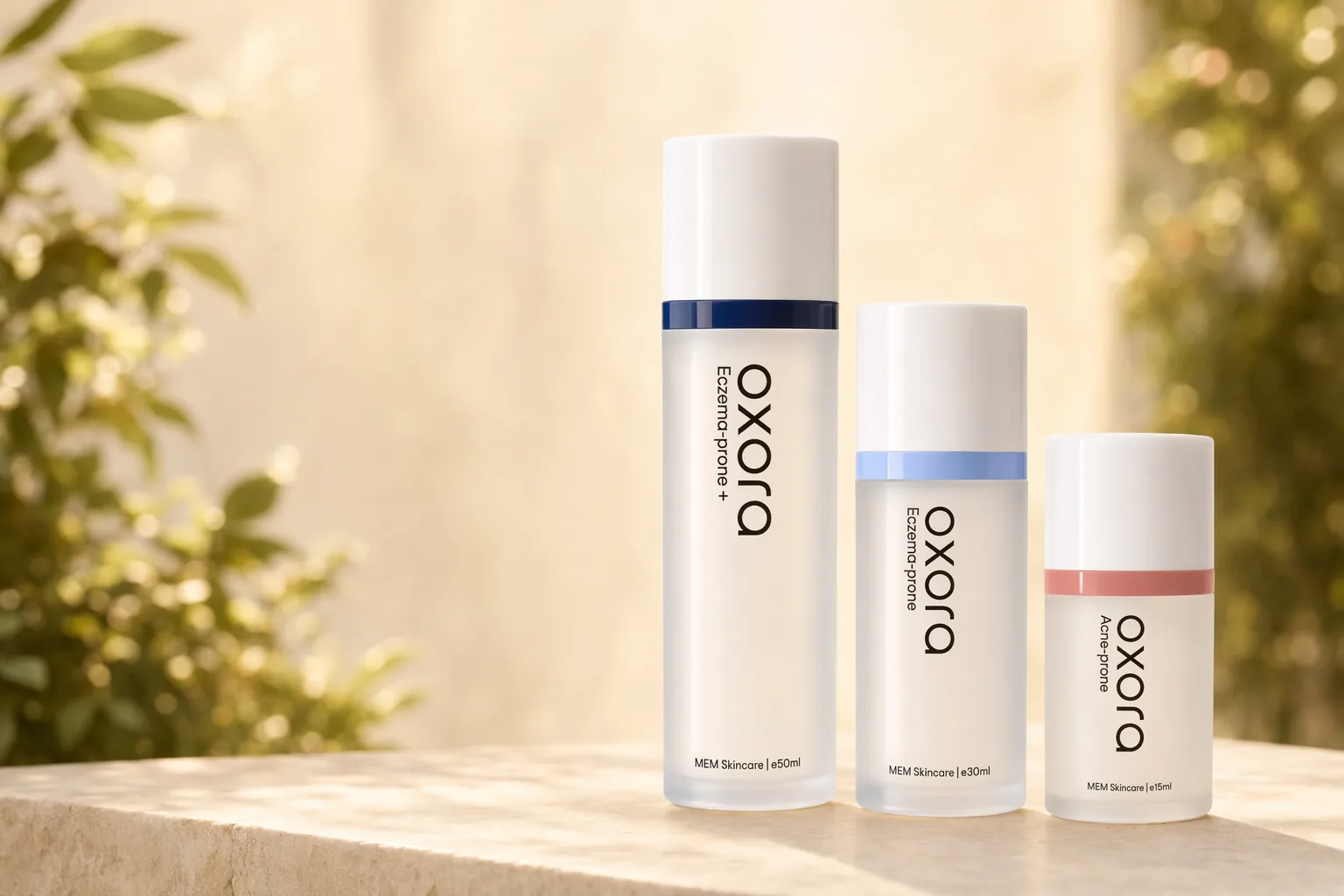 Oxora Acne-prone, EP, and EP Plus on a stone ledge, warm garden bokeh behind